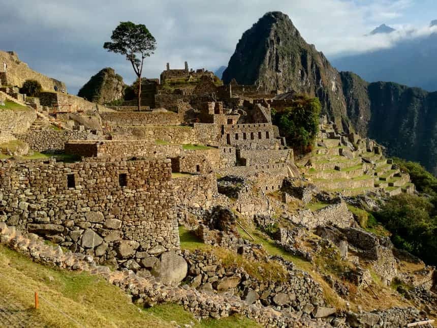 Machu Picchu stone citadel under dramatic mountain light and shifting cloud cover in Urubamba, Cusco