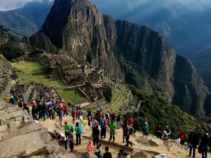 Travelers traversing the designated stone circuits and upper terraces of Machu Picchu ancient citadel